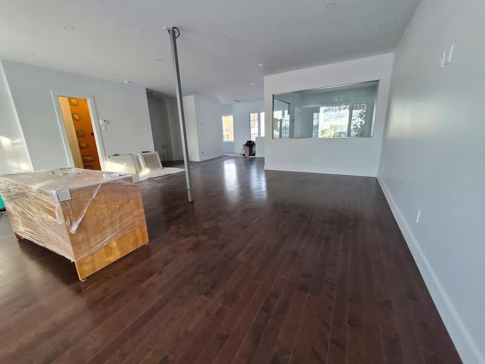 Même pièce terminée avec plancher de bois franc foncé